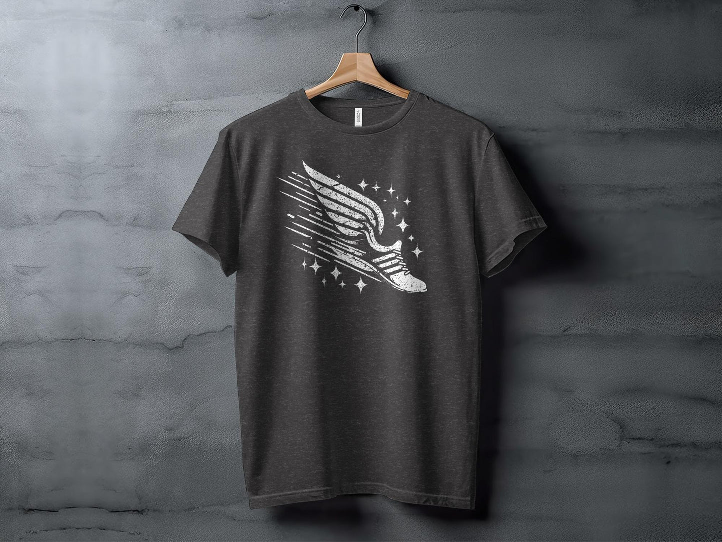 Dark grey t-shirt with a graphic of a winged running shoe and sparkling stars.