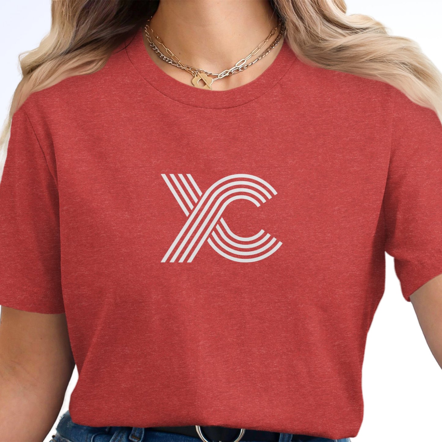 Woman wearing a red t-shirt with a white XC logo.