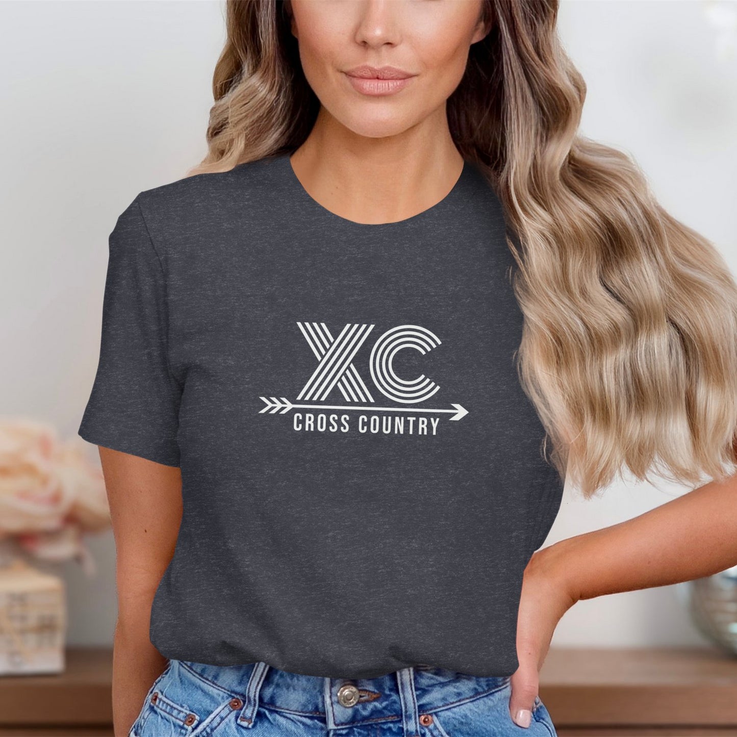 Woman wearing a dark gray t-shirt with a white "XC Cross Country" design.